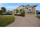 Grand two-story home with circular driveway and landscaped yard at 119 8Th E St, Tierra Verde, FL 33715