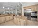 Island kitchen features granite countertops and stainless steel appliances at 119 8Th E St, Tierra Verde, FL 33715