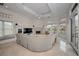 Expansive living room with a curved sectional sofa, fireplace, and water views at 119 8Th E St, Tierra Verde, FL 33715