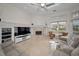 Large living room boasts a fireplace, built-in shelving, and ample natural light at 119 8Th E St, Tierra Verde, FL 33715
