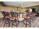 Outdoor kitchen with granite countertops, pizza oven, and bar seating at 119 8Th E St, Tierra Verde, FL 33715