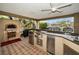 Well-equipped outdoor kitchen featuring a pizza oven and stainless steel appliances at 119 8Th E St, Tierra Verde, FL 33715