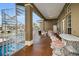 Covered patio with spiral staircase, outdoor seating, and water views at 119 8Th E St, Tierra Verde, FL 33715