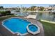 Inviting pool and spa with brick pavers and waterfront access at 119 8Th E St, Tierra Verde, FL 33715
