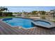 Inviting pool and spa area with brick pavers, perfect for relaxation at 119 8Th E St, Tierra Verde, FL 33715