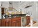 Home bar with granite countertop and wine cooler at 119 8Th E St, Tierra Verde, FL 33715
