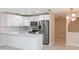 Modern white kitchen with stainless steel appliances and quartz countertops at 12609 Shadow Ridge Blvd, Hudson, FL 34669