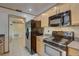 Kitchen with stainless steel appliances and light wood cabinets at 12698 116Th St, Largo, FL 33778