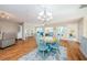 Charming dining area with a round wooden table and teal chairs at 1575 Wicklow Dr, Palm Harbor, FL 34684