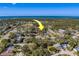 Aerial view showing home's location in a residential neighborhood near the water at 1638 St Catherine W Dr, Dunedin, FL 34698