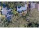 An aerial shot showing the home's backyard and surrounding trees at 1638 St Catherine W Dr, Dunedin, FL 34698