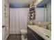 Updated bathroom features a vanity, shower/tub combo, and stylish decor at 1638 St Catherine W Dr, Dunedin, FL 34698