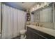 Clean bathroom with a vanity, shower/tub combo and updated fixtures at 1638 St Catherine W Dr, Dunedin, FL 34698