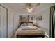 Comfortable bedroom with king-size bed, ceiling fan, and lots of natural light at 1638 St Catherine W Dr, Dunedin, FL 34698