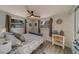 Cozy bedroom with a ceiling fan and nautical-themed bedding at 1638 St Catherine W Dr, Dunedin, FL 34698
