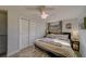 King-size bed, ceiling fan, and ample closet space in this bright bedroom at 1638 St Catherine W Dr, Dunedin, FL 34698