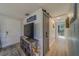 Bright entryway with a barn door, TV, and storage shelving at 1638 St Catherine W Dr, Dunedin, FL 34698