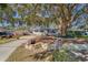 House exterior with a manicured lawn and stone wall at 1638 St Catherine W Dr, Dunedin, FL 34698