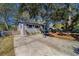 House exterior with a driveway and mature landscaping at 1638 St Catherine W Dr, Dunedin, FL 34698