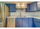 Modern kitchen with blue cabinets and stainless steel appliances at 1638 St Catherine W Dr, Dunedin, FL 34698