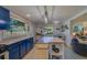 Stylish kitchen with blue cabinets, stainless steel appliances and kitchen island at 1638 St Catherine W Dr, Dunedin, FL 34698