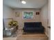 Bright office features a comfortable couch, a work desk and plenty of natural light at 1638 St Catherine W Dr, Dunedin, FL 34698