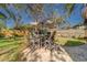 Patio with table, chairs, and umbrella providing a relaxing outdoor space at 1638 St Catherine W Dr, Dunedin, FL 34698
