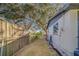 A side yard with a wooden fence and small landscaping at 1638 St Catherine W Dr, Dunedin, FL 34698