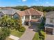 Two-story home with a tile roof, a paved driveway, and landscaping at 17907 Woodland View Dr, Lutz, FL 33548