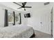 Bedroom with ceiling fan, window, and wall-mounted TV at 18136 Sandy Pointe Dr, Tampa, FL 33647