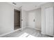 Bedroom with doors to bathroom and closet, featuring light grey walls and flooring at 205 Circle Hill Dr, Brandon, FL 33510