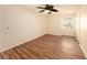 Spacious bedroom featuring wood-look floors and a ceiling fan at 2400 Feather Sound Dr # 128, Clearwater, FL 33762