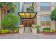 Welcoming entryway with a covered walkway, lush landscaping, and ornate gate at 2440 W Horatio St # 1030, Tampa, FL 33609