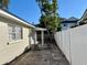 Cozy backyard with a patio and a white fence at 3211 S Ferdinand Ave, Tampa, FL 33629