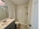 Clean bathroom featuring a shower, a white sink vanity, and wood-look flooring at 3211 S Ferdinand Ave, Tampa, FL 33629