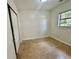 Cozy bedroom with neutral walls, a window for natural light, and a closet at 3211 S Ferdinand Ave, Tampa, FL 33629