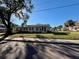 Duplex with a spacious front yard, offering curb appeal and ample parking at 3211 S Ferdinand Ave, Tampa, FL 33629