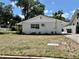 Home's exterior with mature trees and a long driveway at 3211 S Ferdinand Ave, Tampa, FL 33629