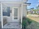 Charming home featuring a glass front door with a white brick facade, offering a warm, inviting welcome at 3211 S Ferdinand Ave, Tampa, FL 33629