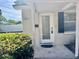 Charming home featuring a glass front door with a white brick facade, offering a warm, inviting welcome at 3211 S Ferdinand Ave, Tampa, FL 33629