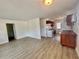 Bright living room featuring stylish flooring, and a partial view of the kitchen with white appliances at 3211 S Ferdinand Ave, Tampa, FL 33629