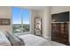 Comfortable bedroom with large windows, a dresser, and views of the cityscape at 3401 Bayshore Blvd # 1904, Tampa, FL 33629