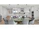 Modern dining area with a glass-top table and gray chairs, open to kitchen at 3401 Bayshore Blvd # 1904, Tampa, FL 33629