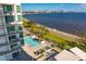 Relaxing pool area with city views, lounge chairs, and palm trees at 3401 Bayshore Blvd # 1904, Tampa, FL 33629