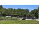 Fenced dog park with grassy area, benches, and waste disposal at 3969 106Th N Ave, Clearwater, FL 33762