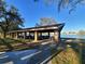 Relaxing lakeside gazebo with picnic tables, ideal for outdoor gatherings at 3969 106Th N Ave, Clearwater, FL 33762