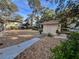 Backyard with gravel, a shed, and a concrete pathway at 405 Tennessee Ave, Crystal Beach, FL 34681