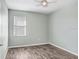 Spacious bedroom featuring wood-look floors and a ceiling fan at 4214 Duck Creek Way, Ellenton, FL 34222