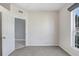 Bright bedroom with grey carpet, neutral walls, and a large window at 4214 Duck Creek Way, Ellenton, FL 34222