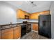 Galley kitchen with dark wood cabinets and black appliances at 5006 Starfish Se Dr # C, St Petersburg, FL 33705